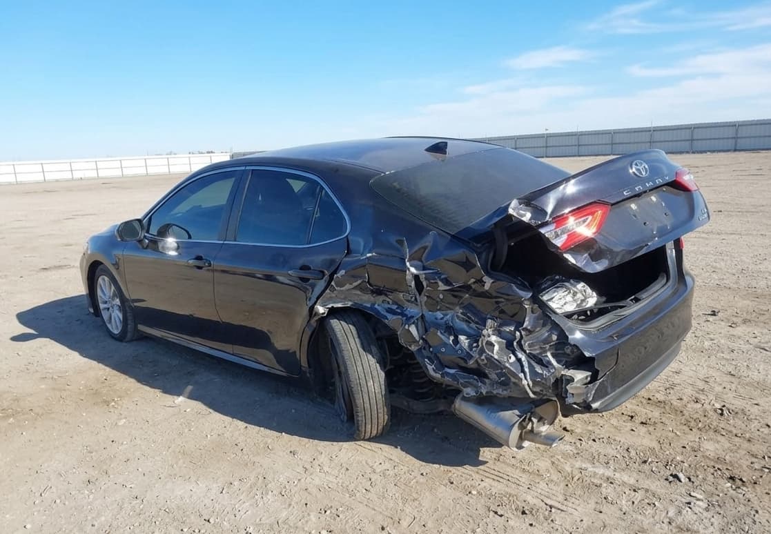 2020 Toyota Camry LE with rear-end accident damage